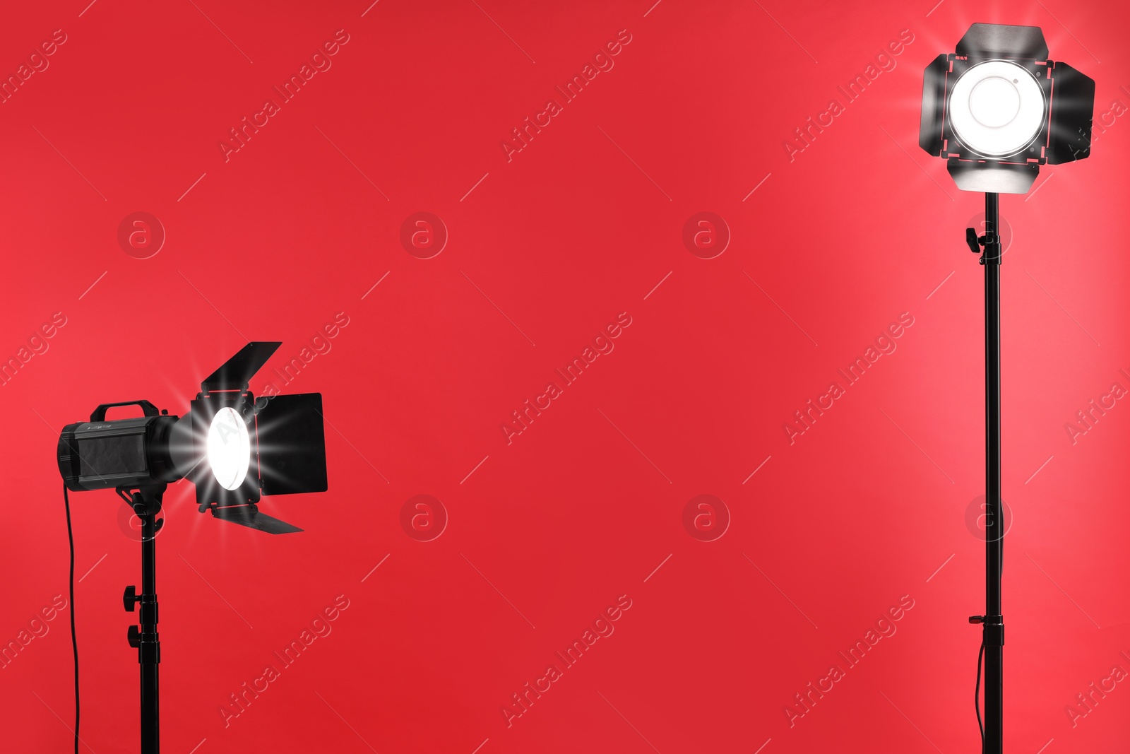 Photo of Red photo background and professional lighting equipment in studio