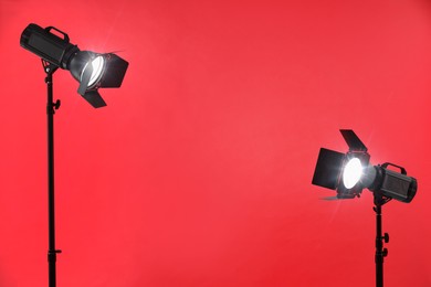 Photo of Red photo background and professional lighting equipment in studio