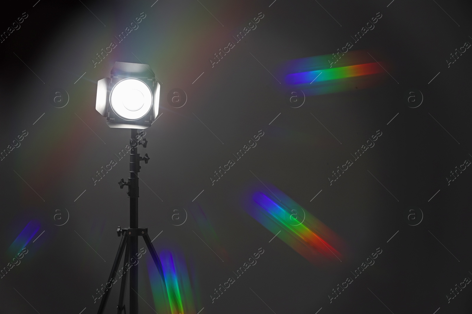 Photo of Dark photo background and professional lighting equipment in studio, space for text