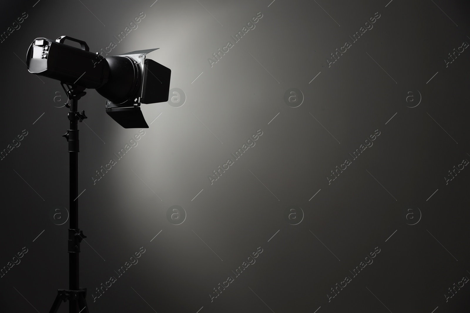 Photo of Dark photo background and professional lighting equipment in studio, space for text