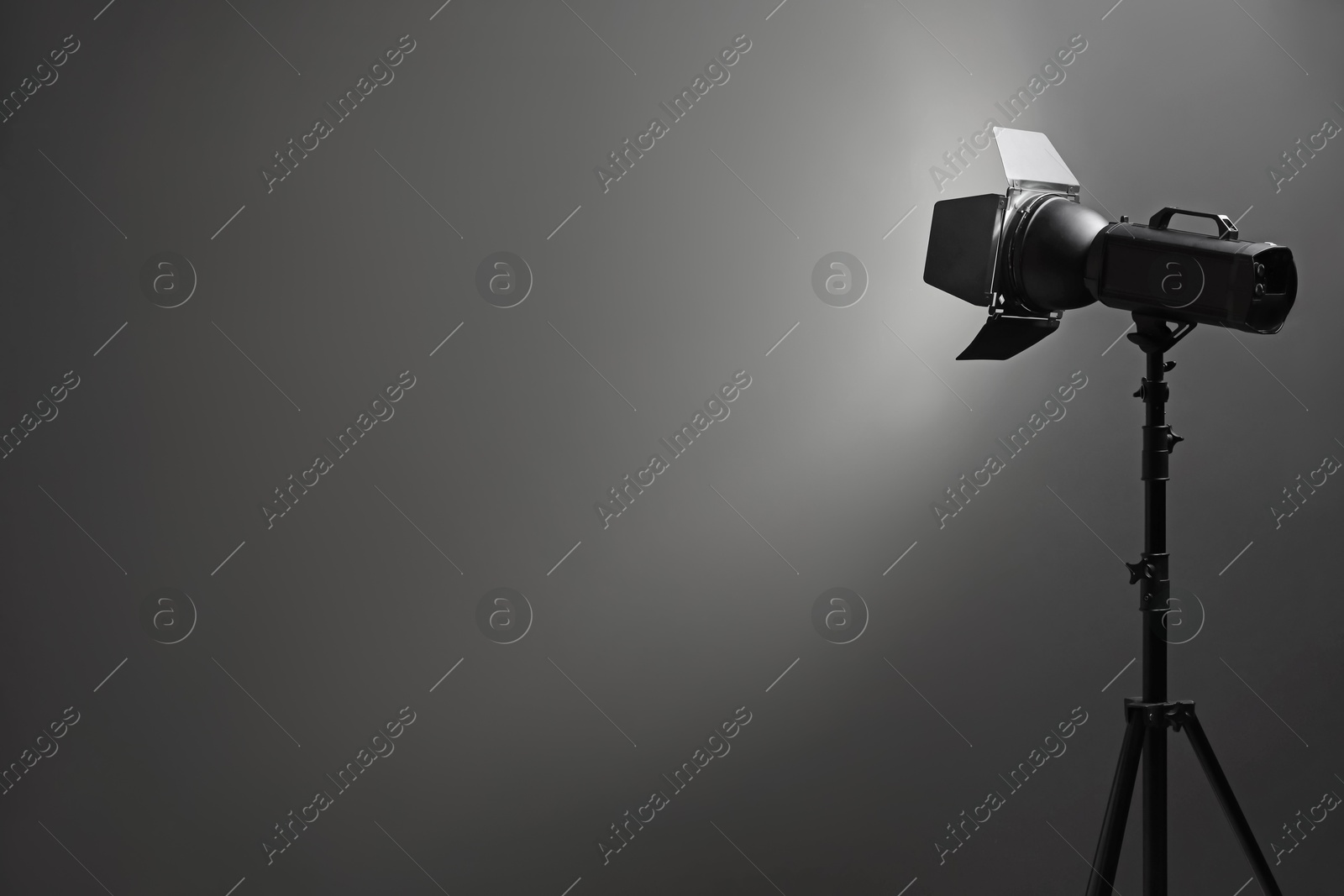 Photo of Dark photo background and professional lighting equipment in studio, space for text