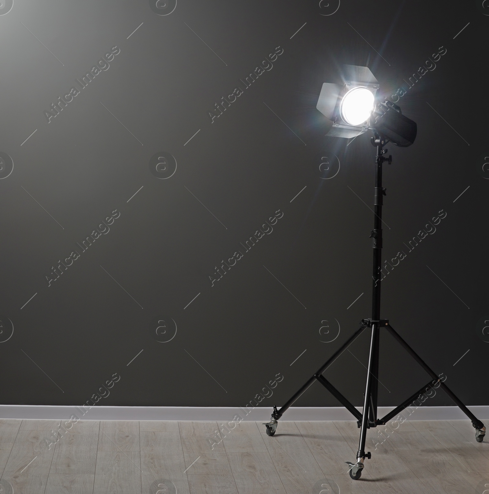 Photo of Dark photo background and professional lighting equipment in studio, space for text