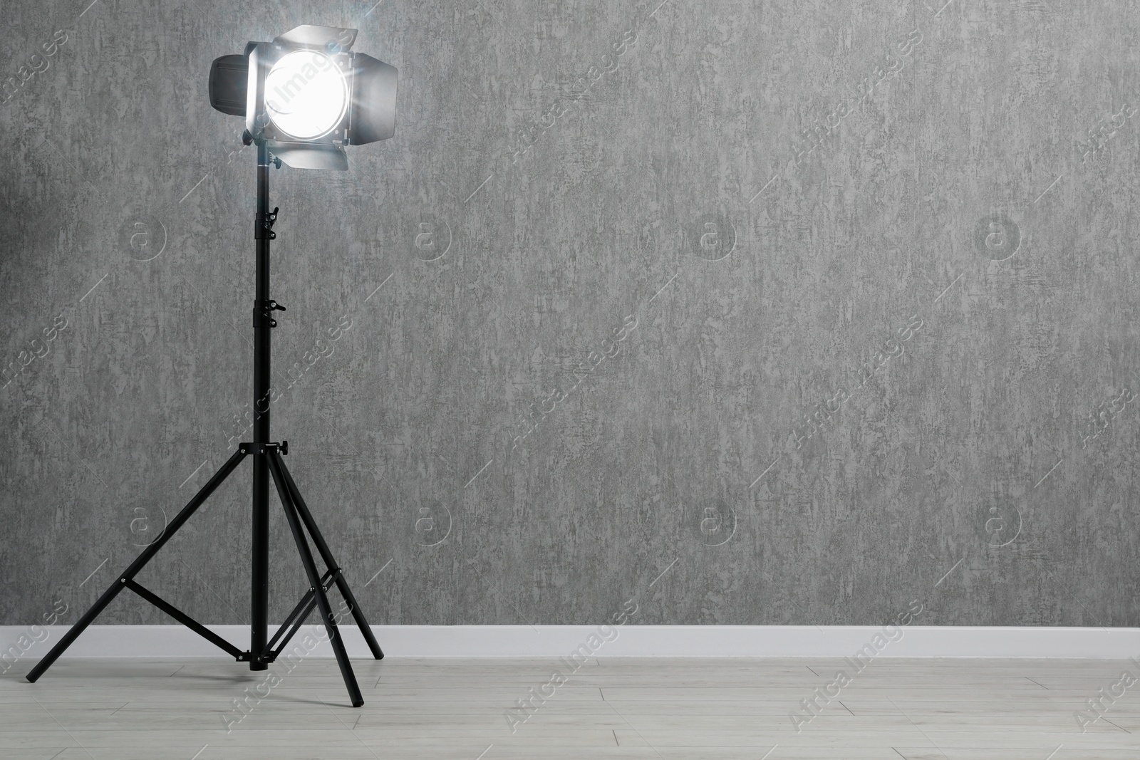 Photo of Grey photo background and professional lighting equipment in studio, space for text