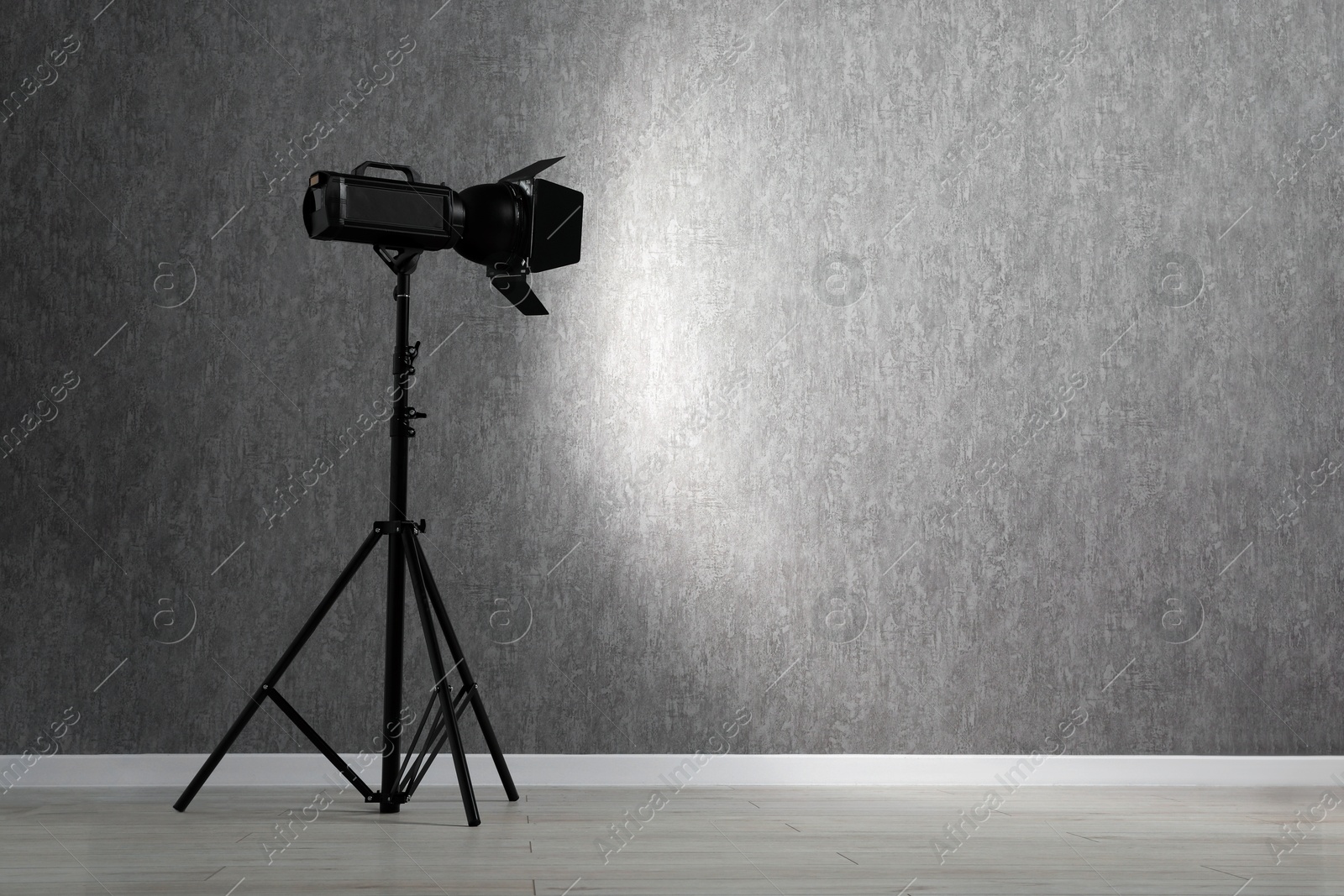 Photo of Grey photo background and professional lighting equipment in studio, space for text