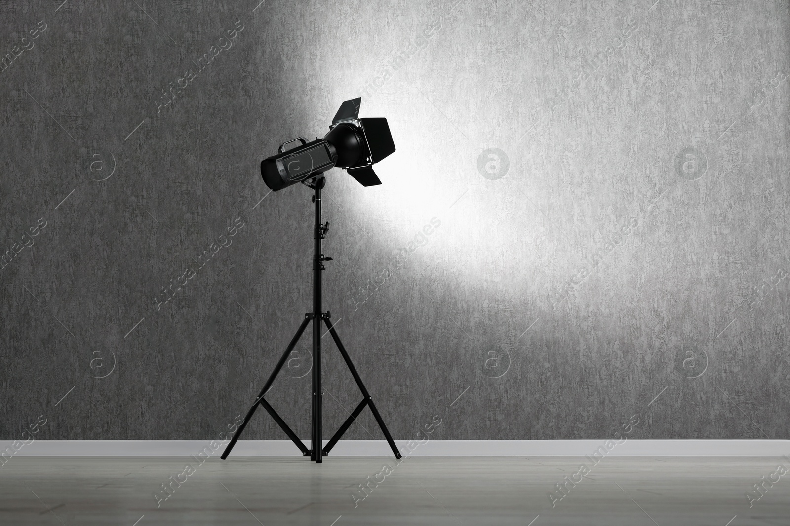 Photo of Grey photo background and professional lighting equipment in studio, space for text