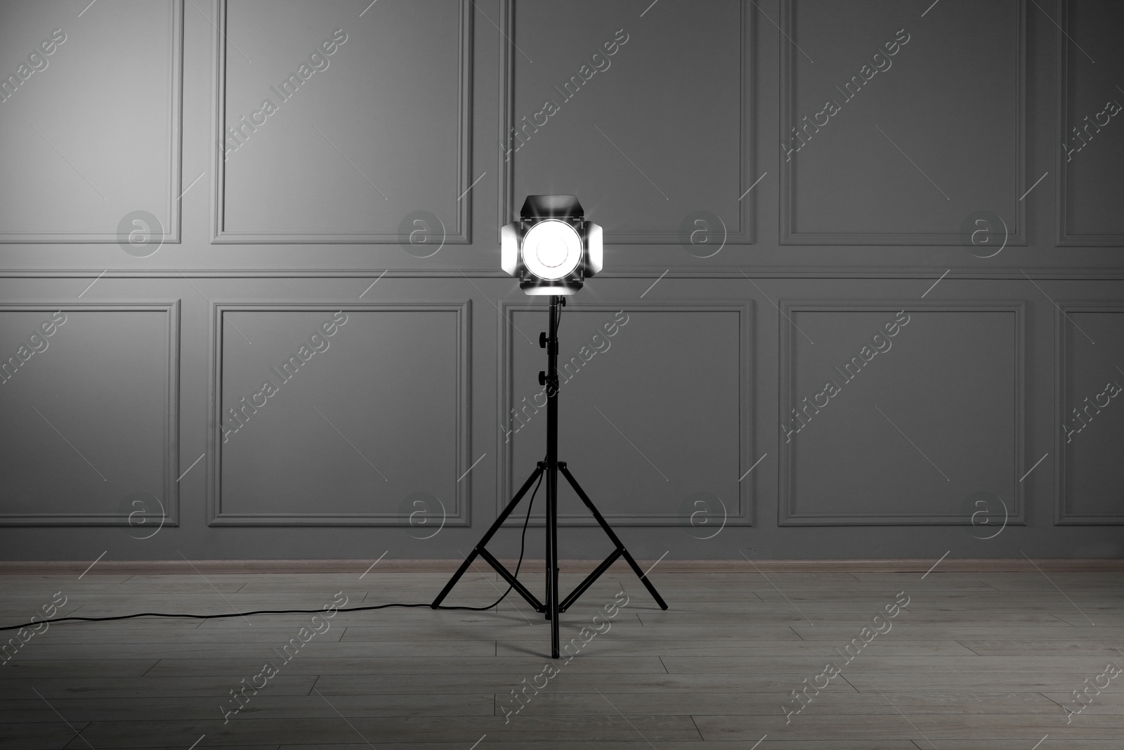 Photo of Professional lighting equipment in modern photo studio