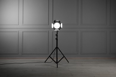 Photo of Professional lighting equipment in modern photo studio