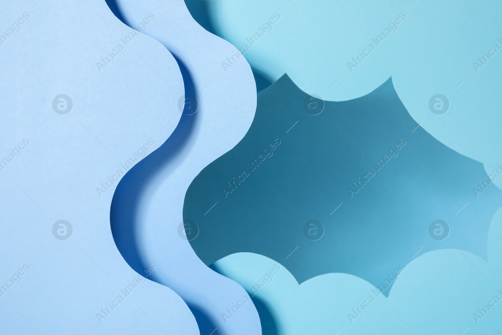 Photo of Presentation of product. Paper cutouts on light blue background. Space for text