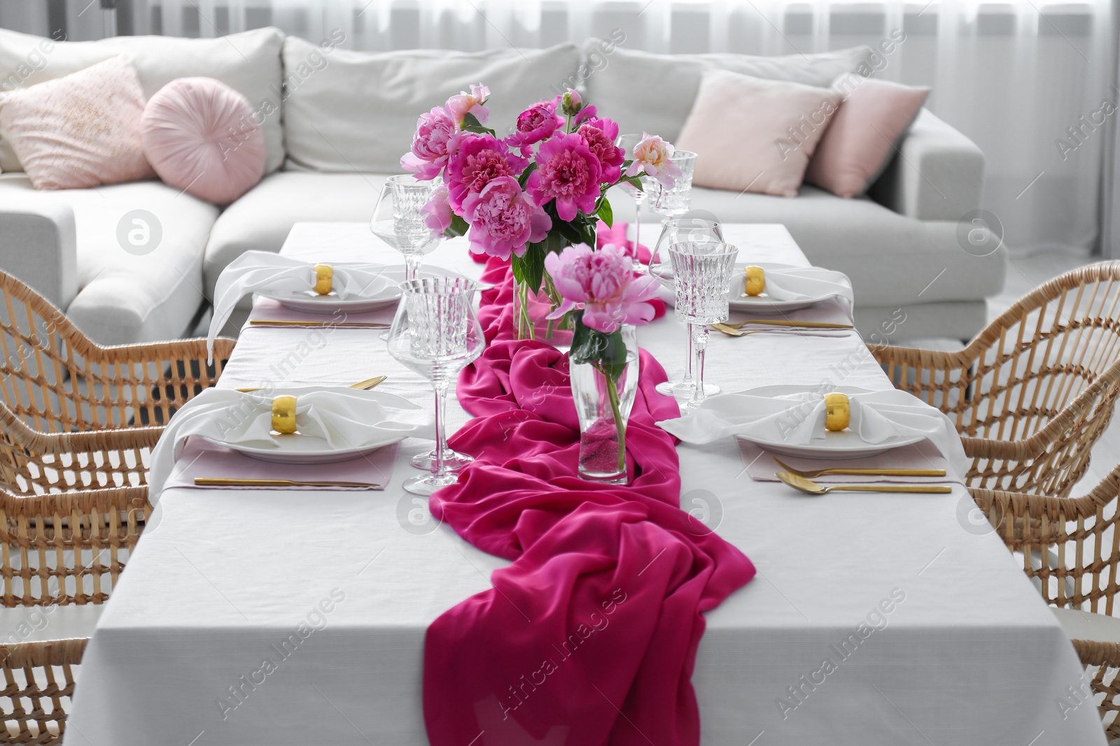 Photo of Beautiful table setting with pink peonies in dining room