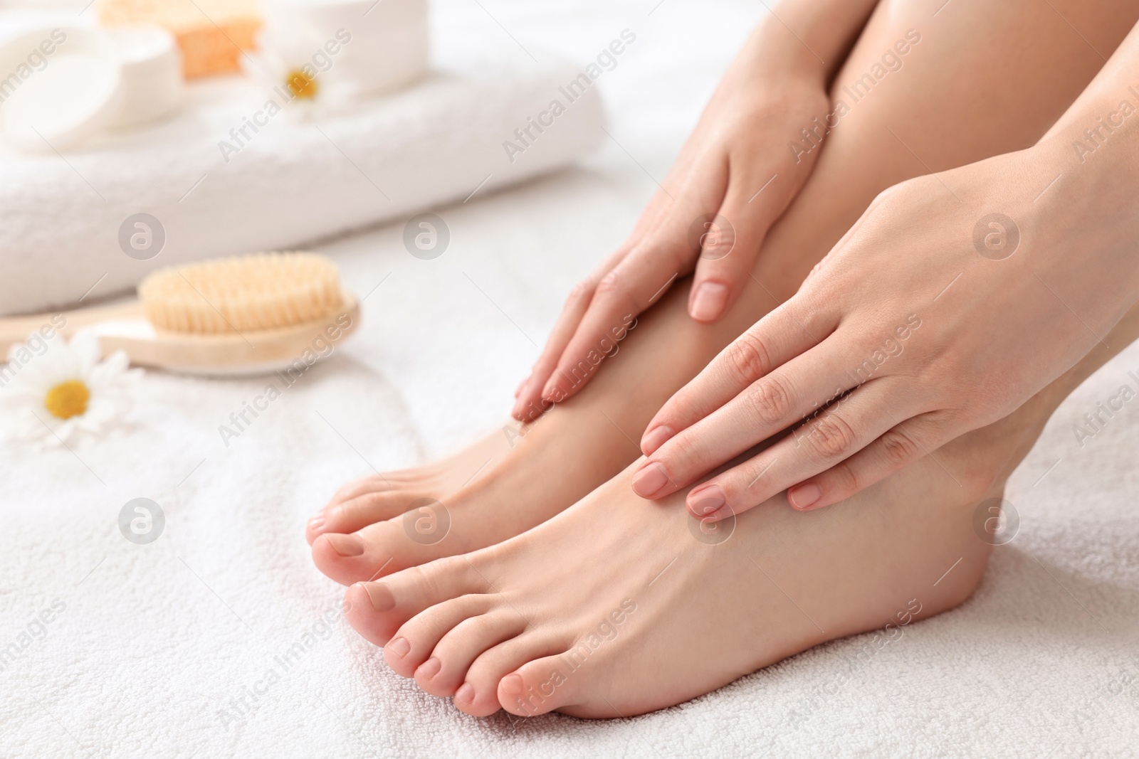 Photo of Closeup view of woman`s groomed feet after care procedure on soft towel