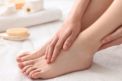 Photo of Closeup view of woman`s groomed feet after care procedure on soft towel