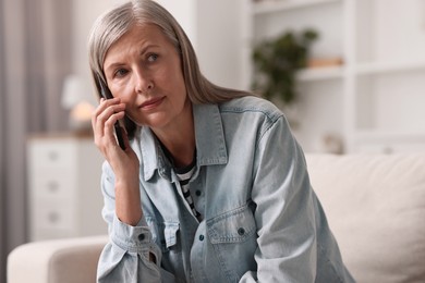 Photo of Senior woman talking on phone at home