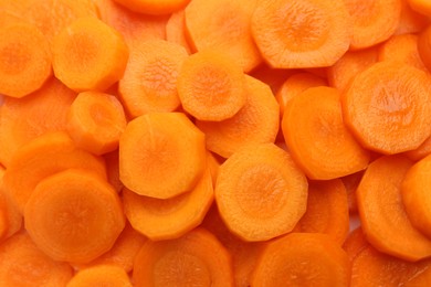 Photo of Slices of fresh ripe carrot as background, top view