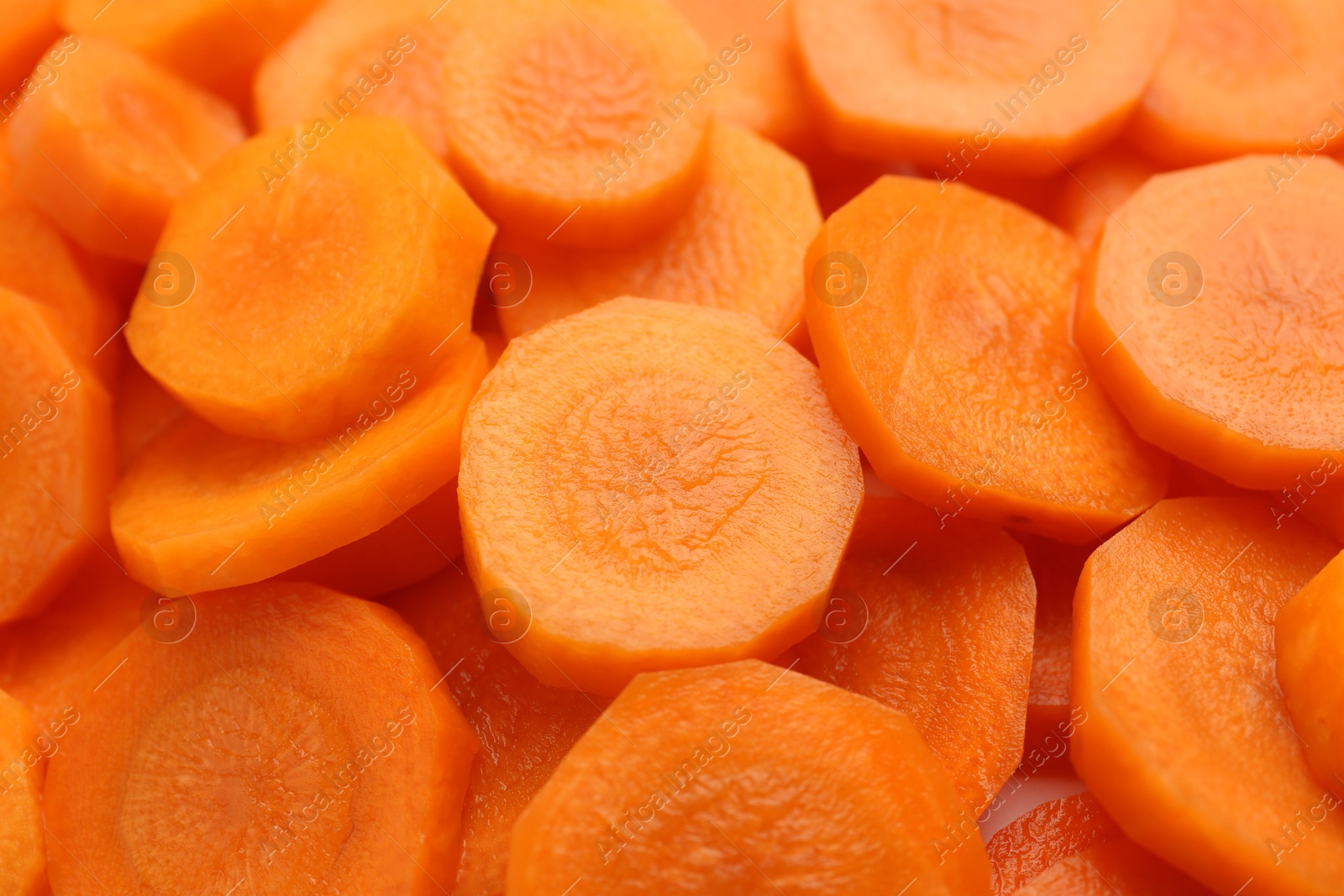 Photo of Slices of fresh ripe carrot as background, closeup