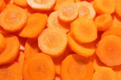 Photo of Slices of fresh ripe carrot as background, top view