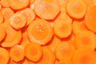 Photo of Slices of fresh ripe carrot as background, top view