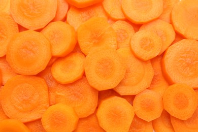 Photo of Slices of fresh ripe carrot as background, top view