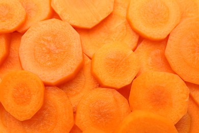 Photo of Slices of fresh ripe carrot as background, top view