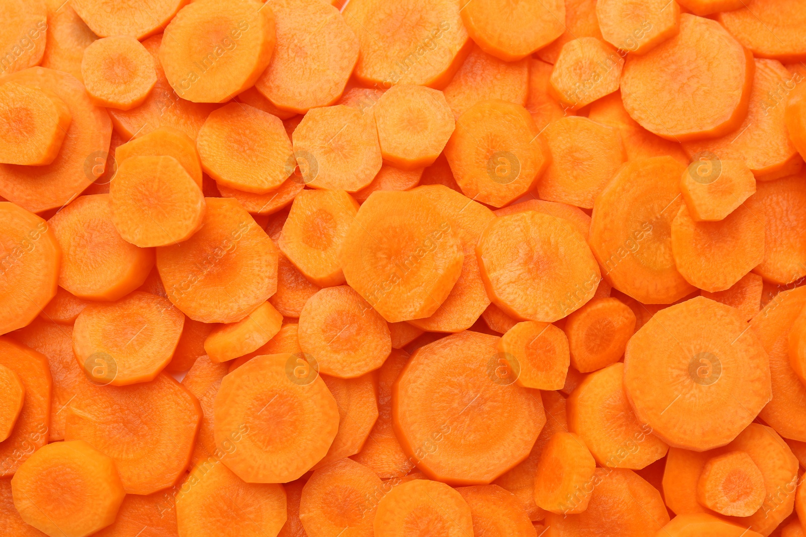 Photo of Slices of fresh ripe carrot as background, top view