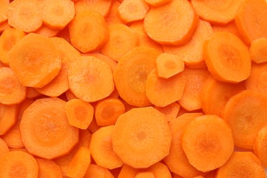 Photo of Slices of fresh ripe carrot as background, top view