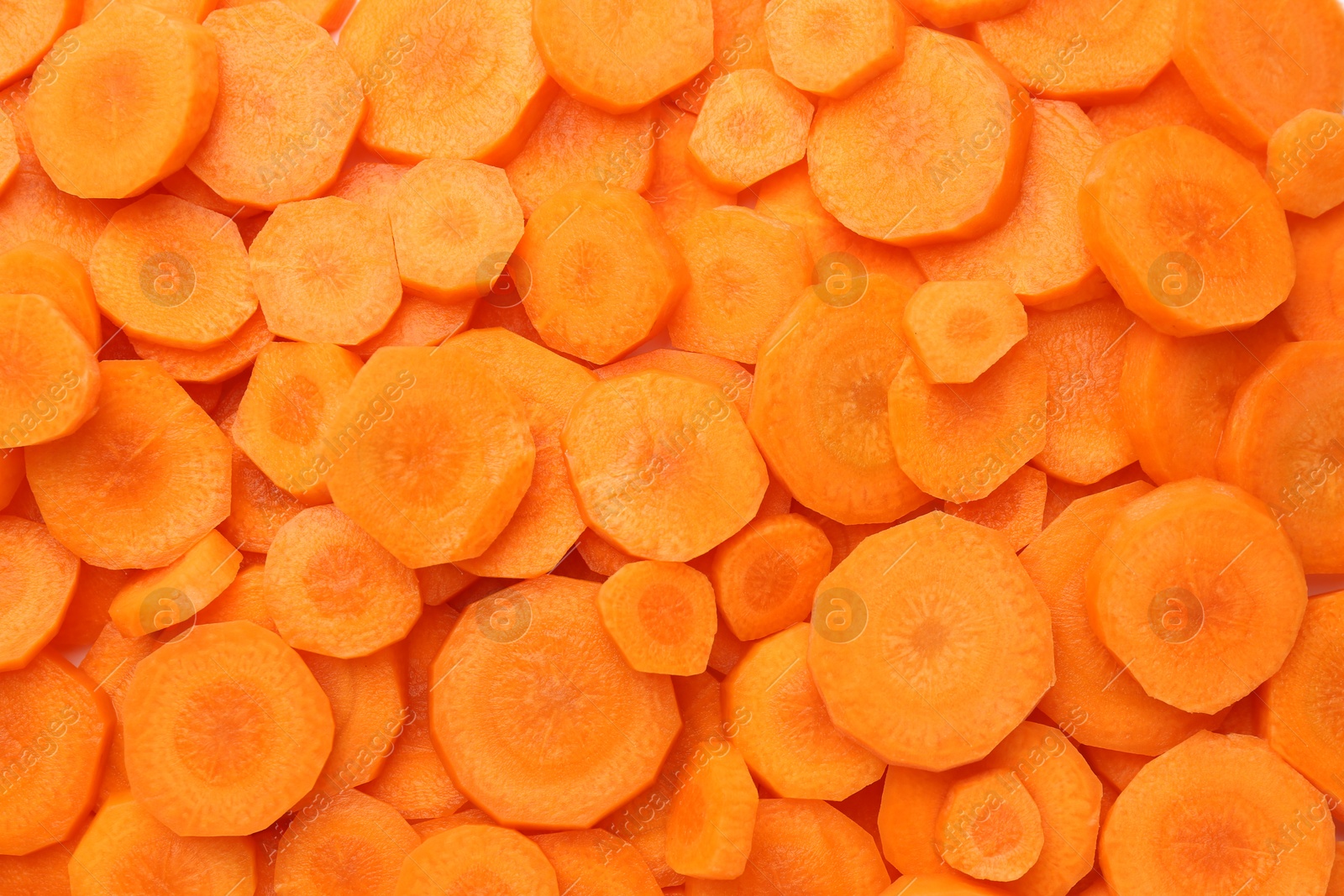 Photo of Slices of fresh ripe carrot as background, top view