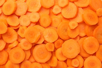 Photo of Slices of fresh ripe carrot as background, top view