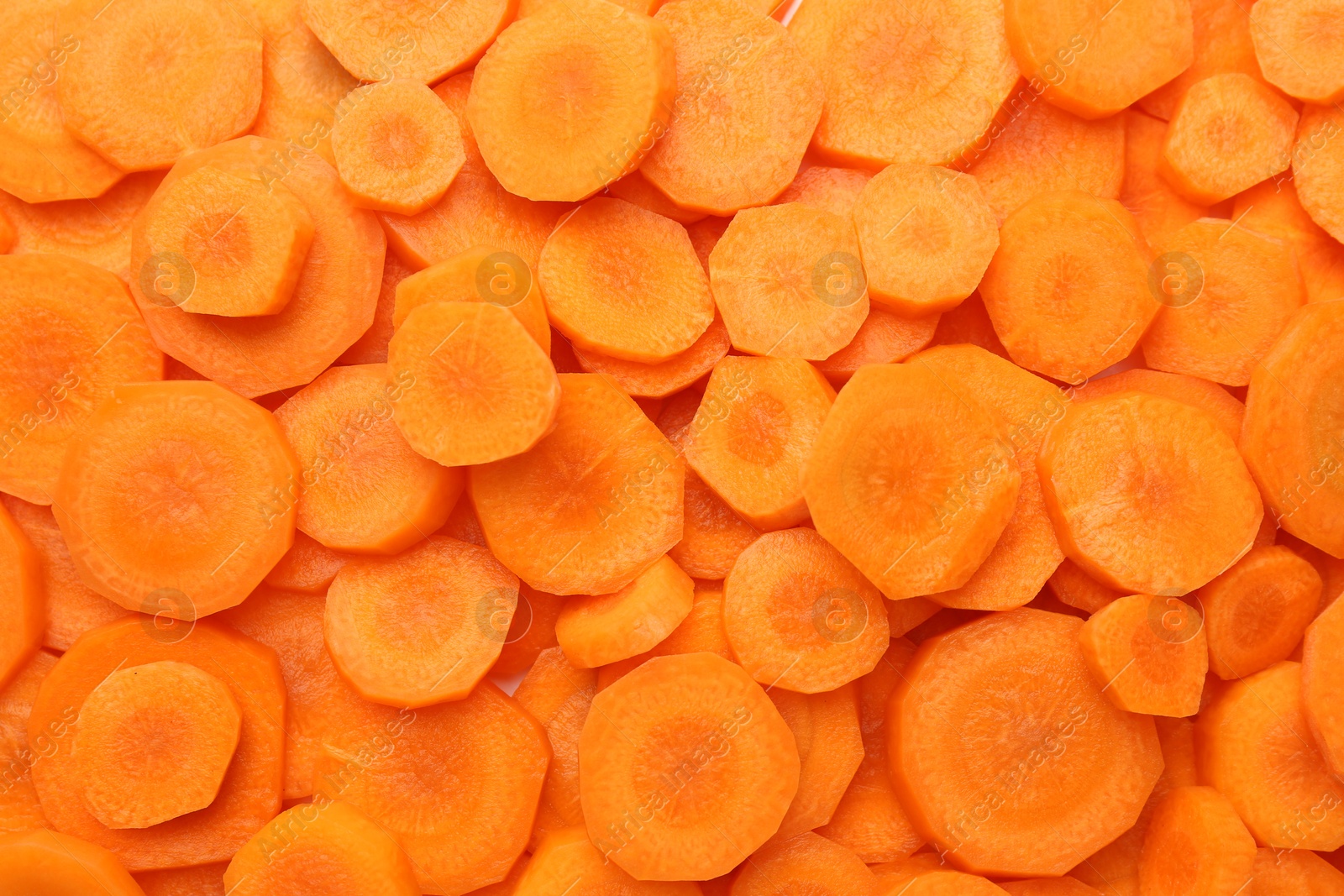 Photo of Slices of fresh ripe carrot as background, top view