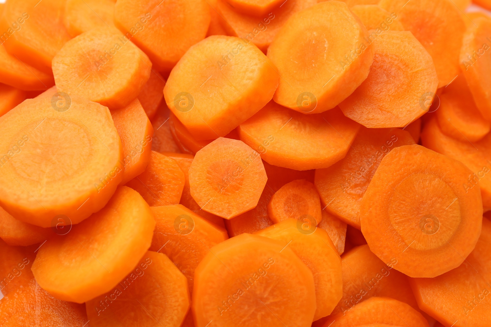 Photo of Slices of fresh ripe carrot as background, top view