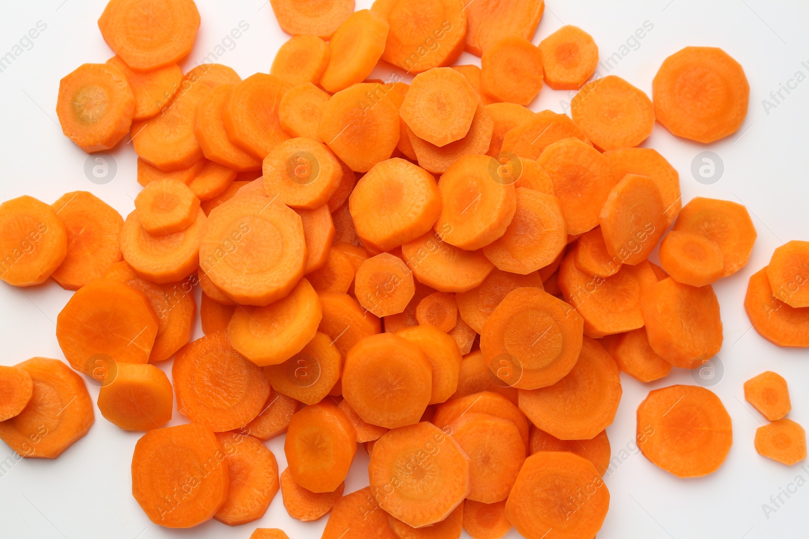 Photo of Slices of fresh ripe carrot on white background, top view