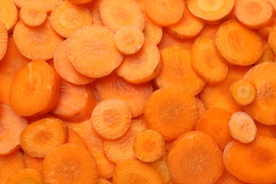 Slices of fresh ripe carrot as background, top view