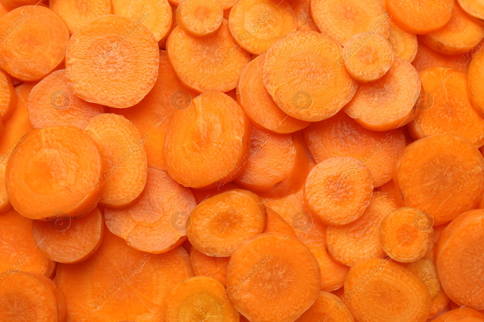 Photo of Slices of fresh ripe carrot as background, top view