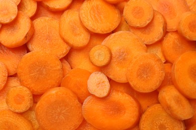 Photo of Slices of fresh ripe carrot as background, top view