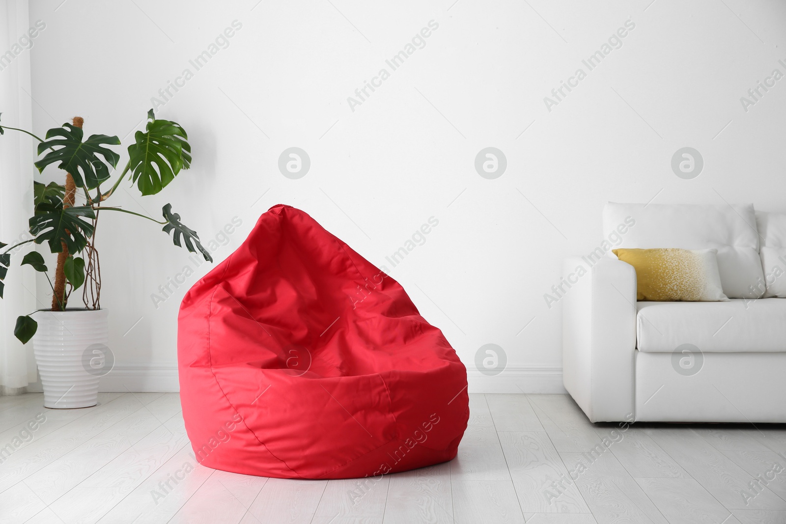 Photo of Red bean bag chair on floor in room