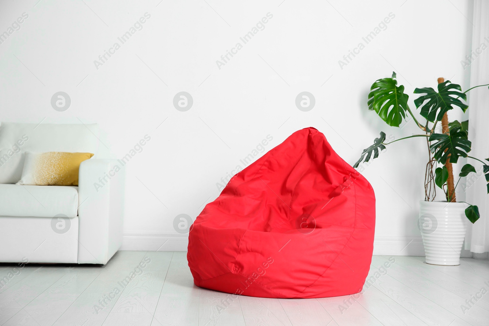 Photo of Red bean bag chair on floor in room