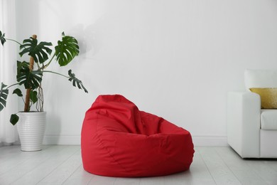 Red bean bag chair on floor in room