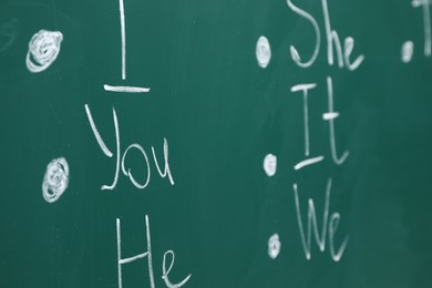 Photo of English grammar rules written with chalk on green board, closeup