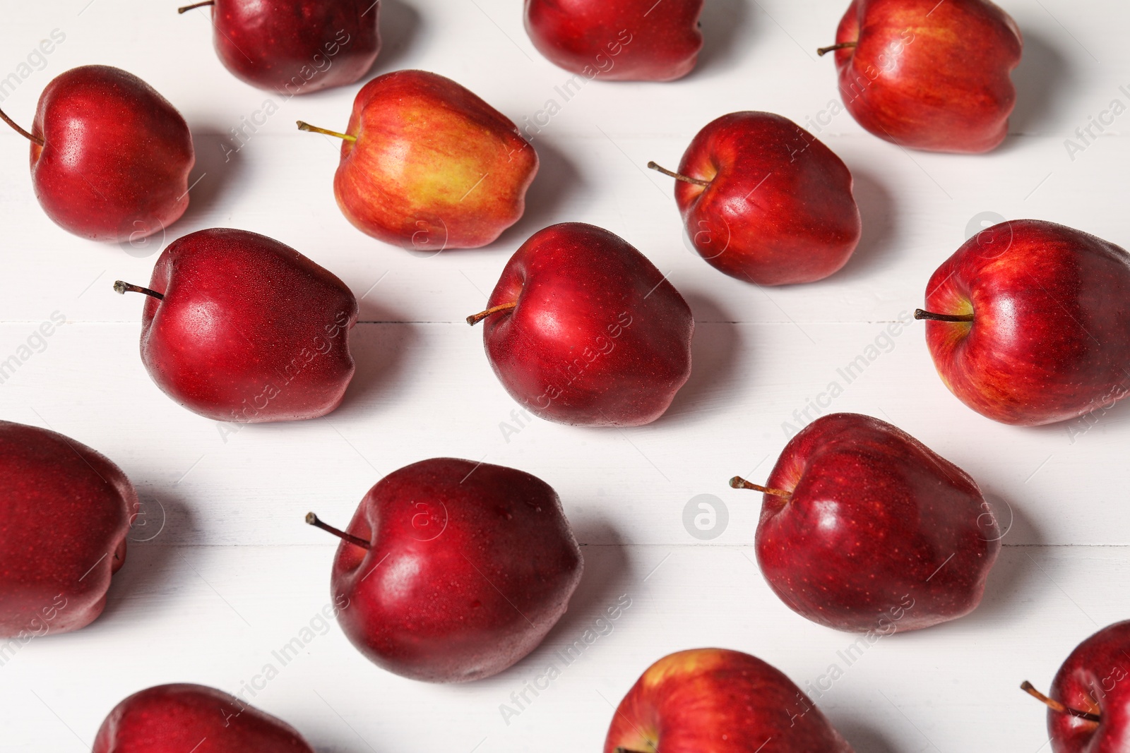 Photo of Fresh red apples on white wooden table