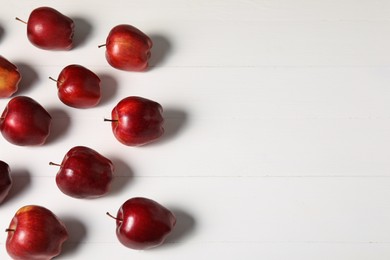 Photo of Fresh red apples on white wooden table, flat lay. Space for text