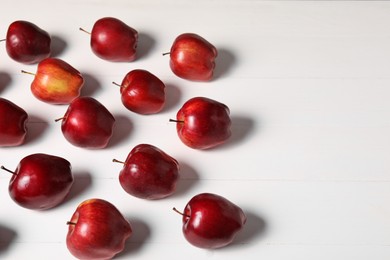 Fresh red apples on white wooden table. Space for text