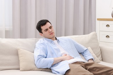 Man suffering from abdominal pain at home