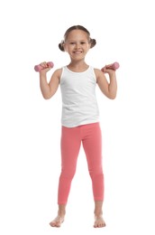 Photo of Cute little girl with dumbbells on white background