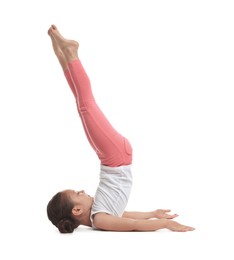 Photo of Cute little girl doing gymnastic exercise on white background