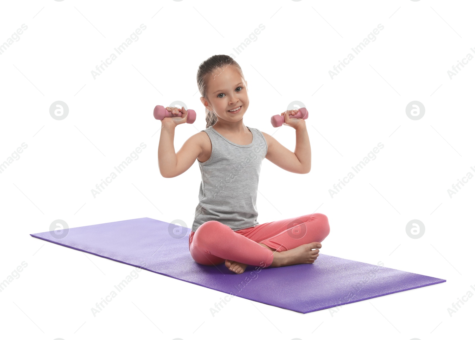 Photo of Cute little girl with dumbbells on white background