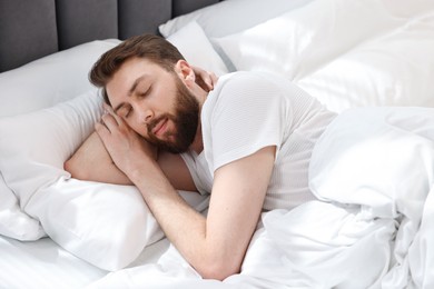 Photo of Handsome young man sleeping in bed at morning