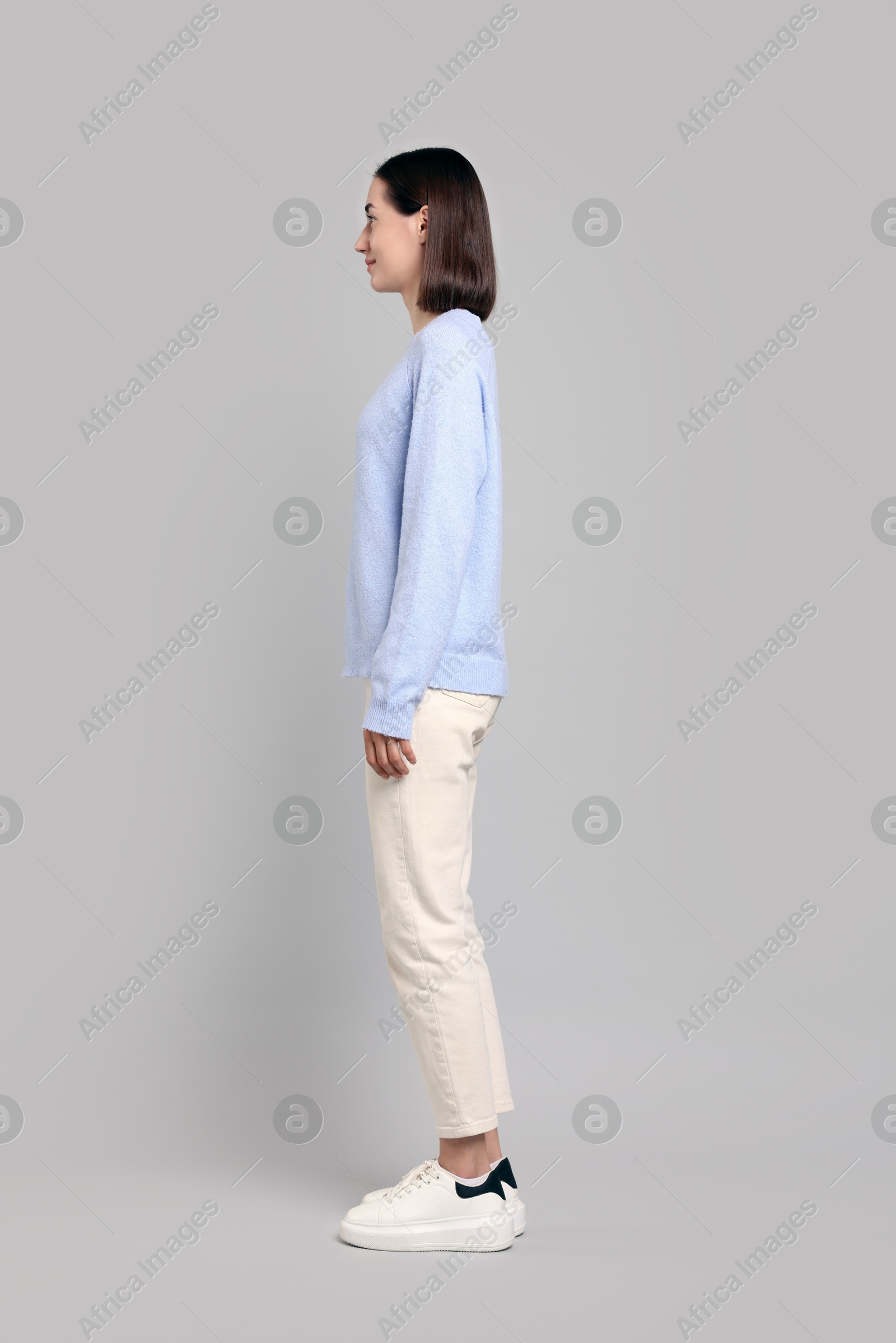 Photo of Woman with good posture on gray background