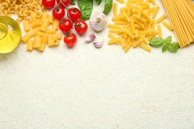 Different types of pasta, spices and products on light table, flat lay. Space for text