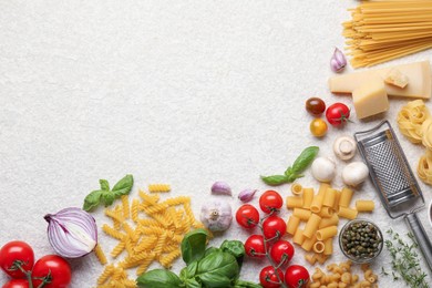 Photo of Different types of pasta, grater, spices and products on light table, flat lay. Space for text