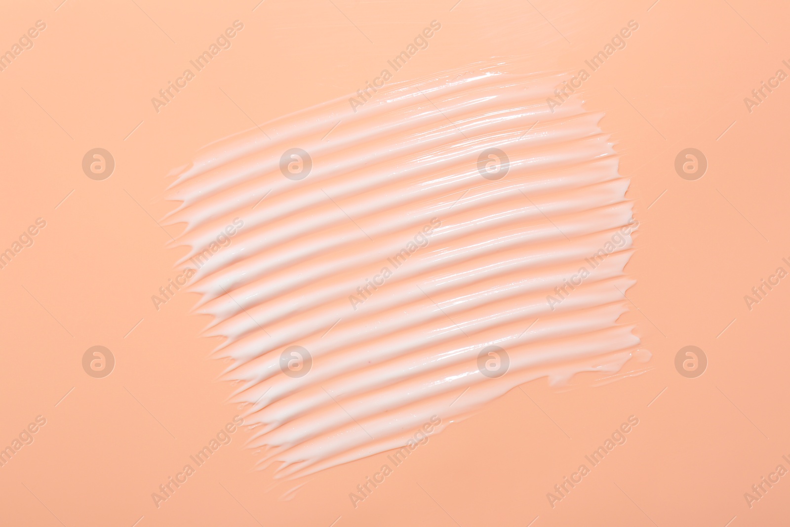 Photo of Face cream on coral background, top view