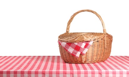 Photo of One picnic basket with napkin on table against white background. Space for text