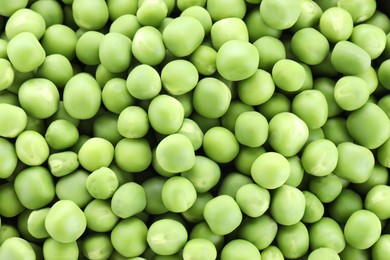 Photo of Fresh raw green peas as background, top view